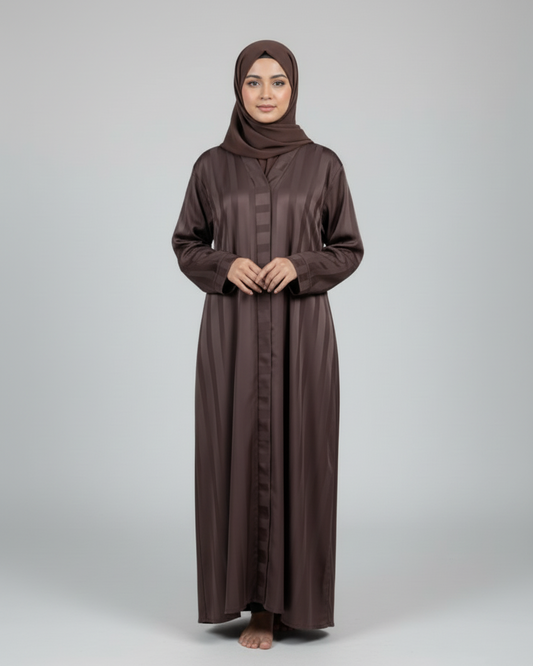 Woman wearing a brown abaya and hijab on a white background