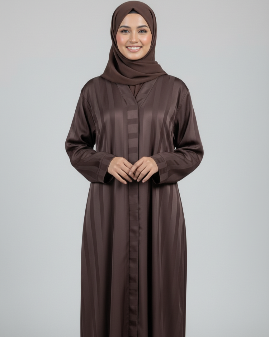 Woman wearing a brown abaya and hijab on a gray background