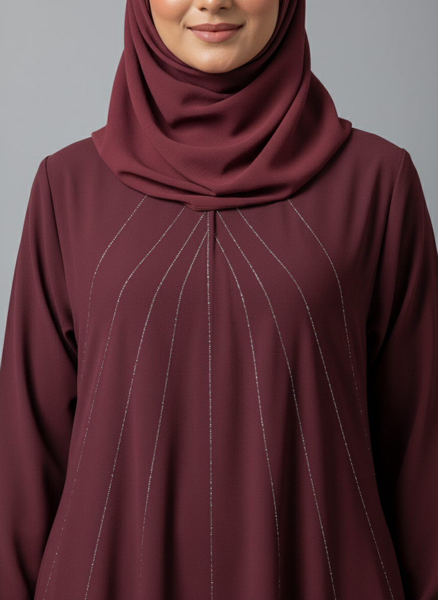 Maroon hijab and top worn by a person on a gray background