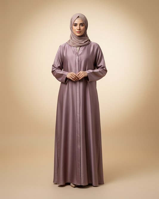 Woman wearing a long, light purple dress and hijab on a beige background